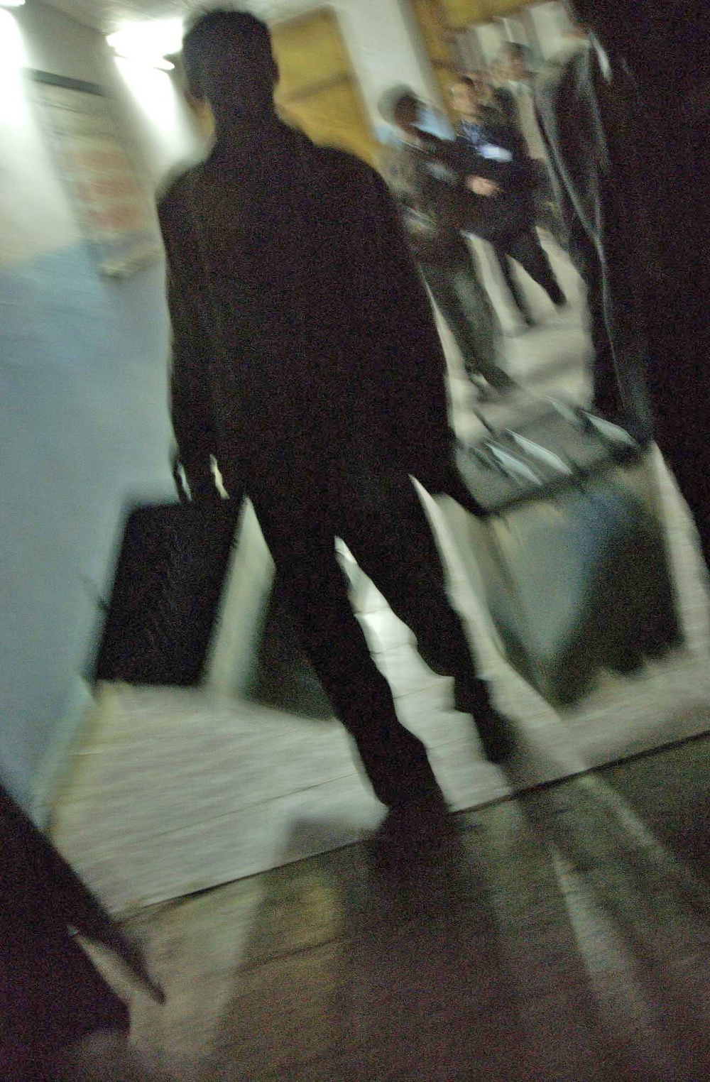 Iraqi polling center workers carry out boxes of ballots