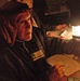 An Iraqi polling center worker goes through the last ballots