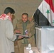 Iraqi citizens cast their votes at the Al Asad polling station