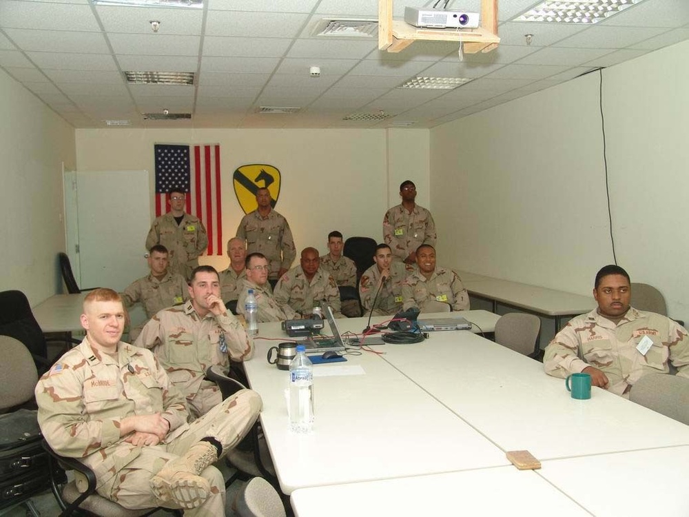 Soldiers watch the Super Bowl XXXIX from their headquarters