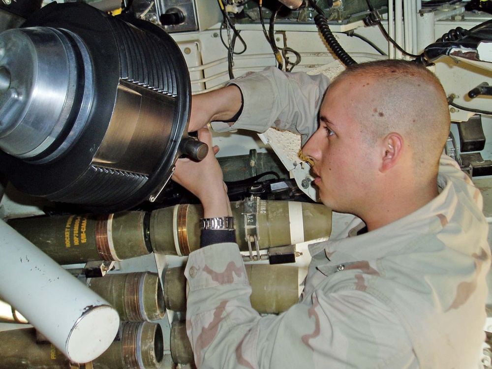 Spc. Ronald Webre cleans the weapon prior to a mission