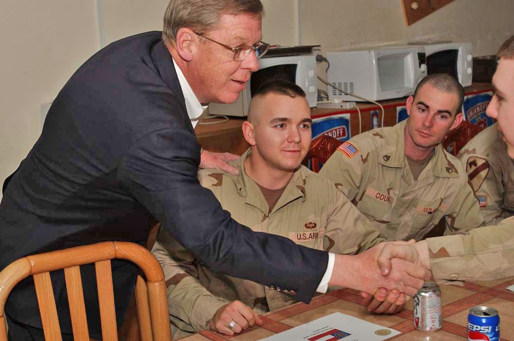 Senator Johnny Isaacson shaking hands with soldiers