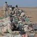 An instructor with the Sniper School watches over Soldiers