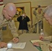 Staff Sgt. Clay Moeller signs re-enlistment papers