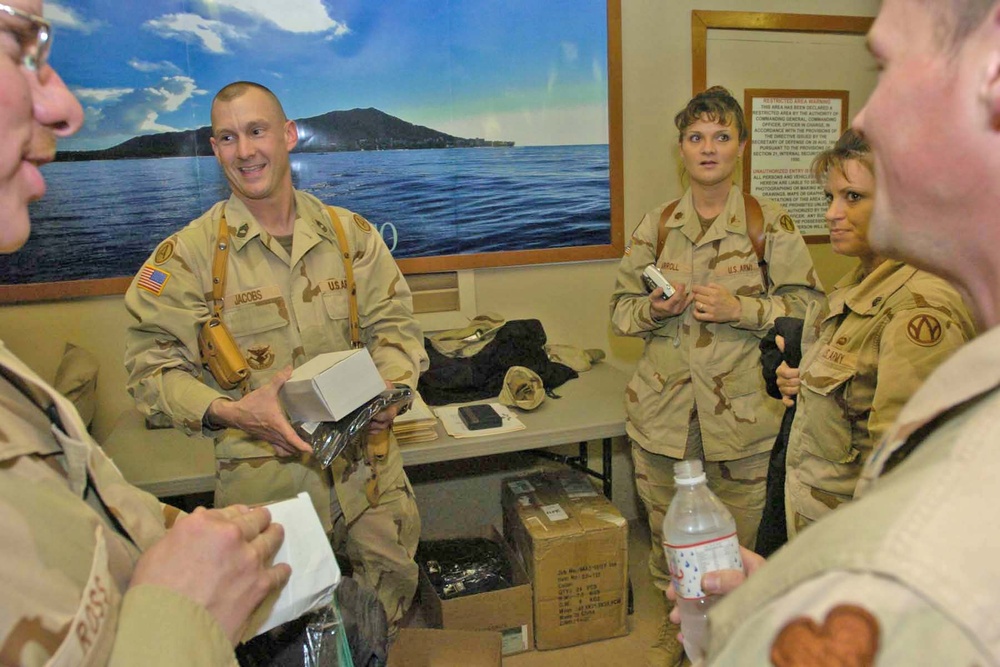 Master Sgt. Gregory Jacobs hands out t-shirts