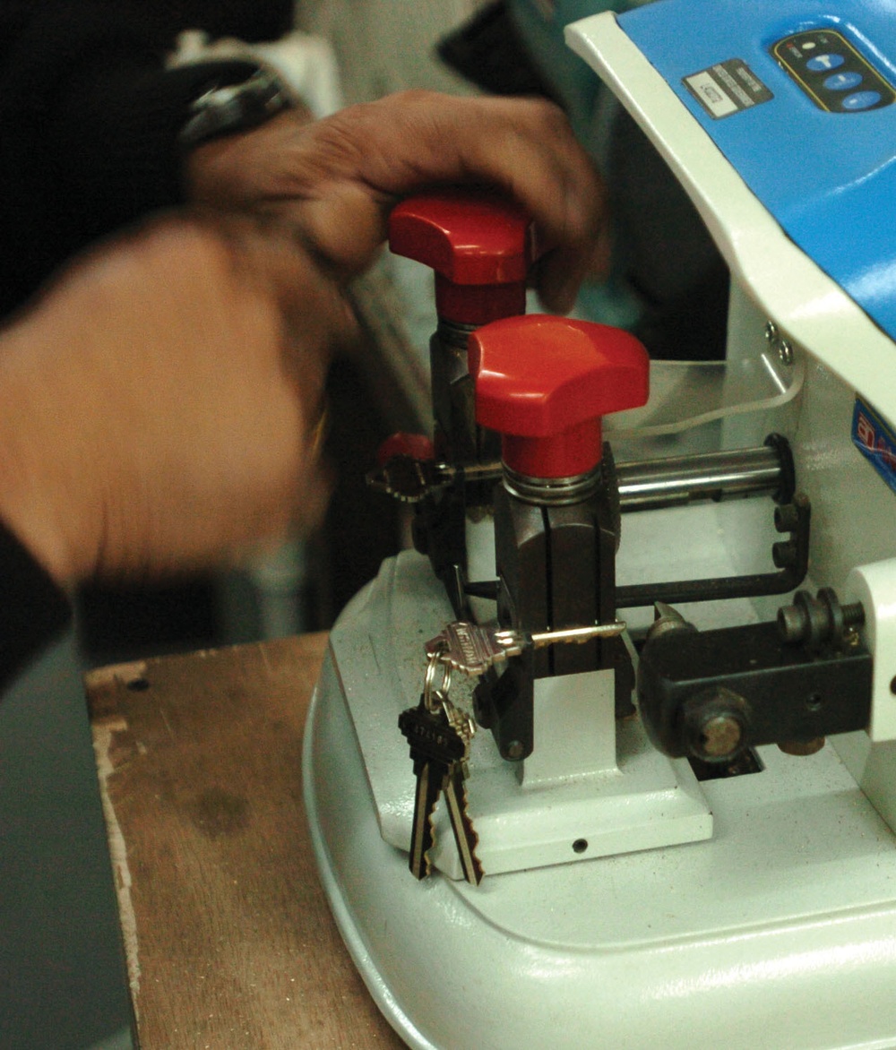 Alfredo Francisco sets a machine to make a copy of a key