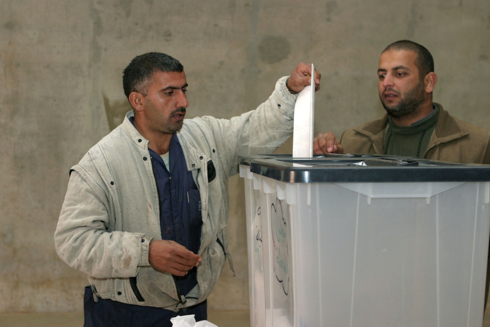 Iraqi citizens cast their votes at the Al Asad polling station