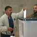 Iraqi citizens cast their votes at the Al Asad polling station