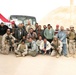 Iraqi citizens and U.S. service members take a group photo