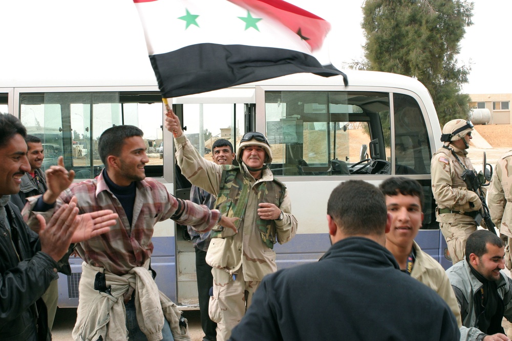 Iraqi soldiers and citizens celebrate in the streets