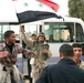 Iraqi soldiers and citizens celebrate in the streets