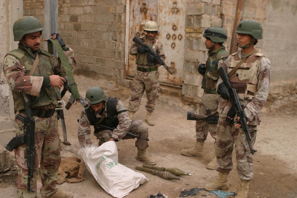 Iraqi Soldiers lay out Rocket Propelled Grenades