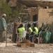 Iraqi civilians exit the voting area