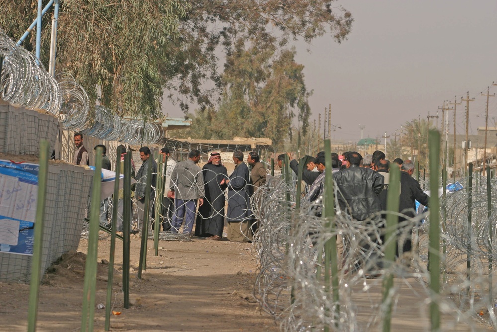 Iraqi civilians line up to vote