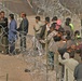 Iraqi civilians line up to vote at the Humanitarian Aid Site