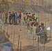 Iraqi civilians line up to vote at the Humanitarian Aid Site