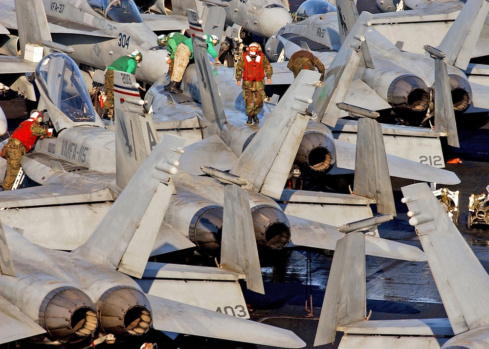 Sailors perform maintenance on aircraft from CVW-3