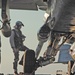 A pilot enters his aircraft prior to flight operations