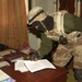 During a raid, A Soldier reads paperwork found