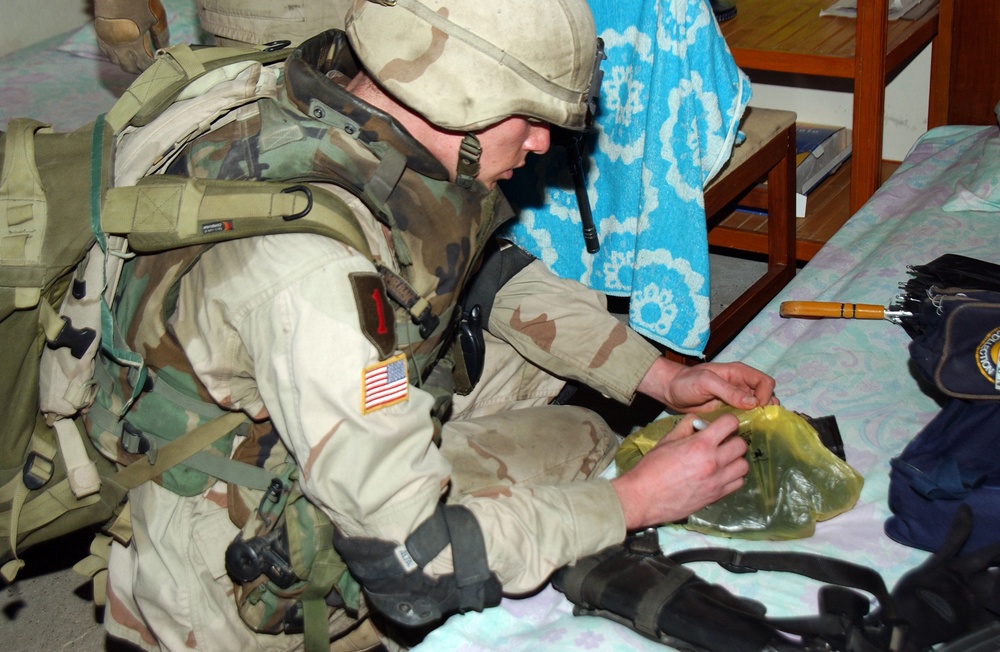 Spc. Patton labels a bag filled with AK-47 magazines