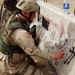 Sgt. Seybold spray- paints over an anti-USA slogan