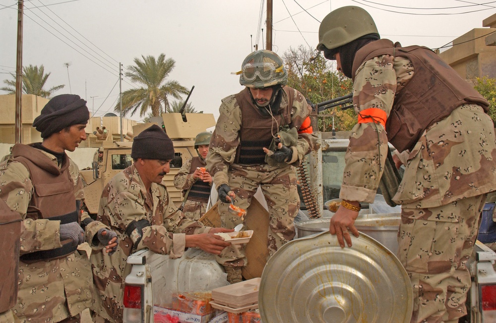 Members of the Iraqi National Guard serve lunch