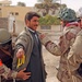 Iraqi National Guardsmen search a voter
