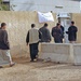 Iraqi voters move into a polling station in a village