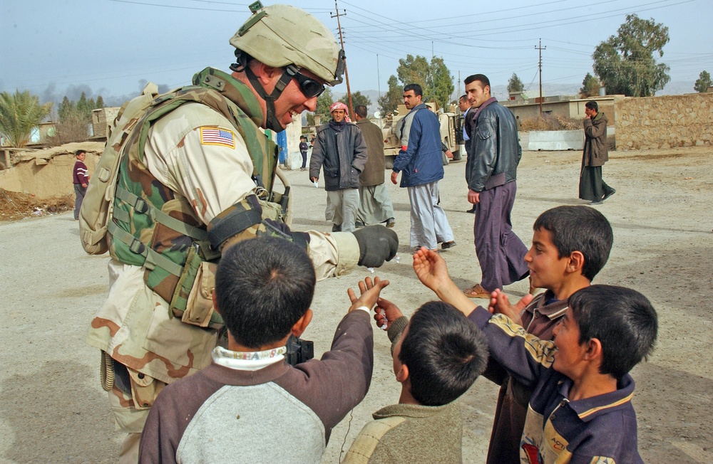 Sgt. Maj. Ichina gives candy to local children