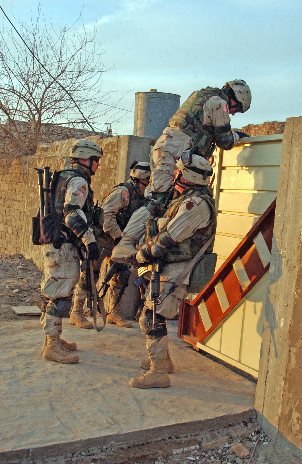 Spc. Shalllenberg gets a boost from a fellow Soldier