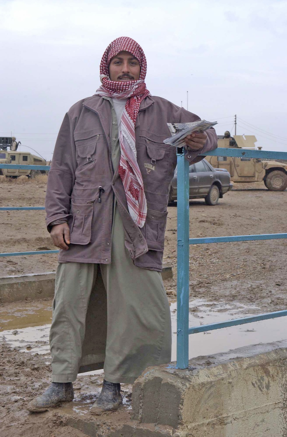 An Iraqi man holds voting flyers that he will hand out