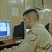 Spc. Michael Carmack Uses a Computer to Contact Home