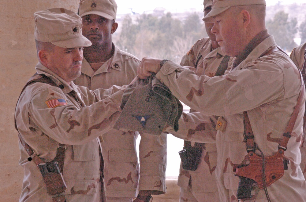 Lt. Col. Raymond Lacey rolls his units guidon