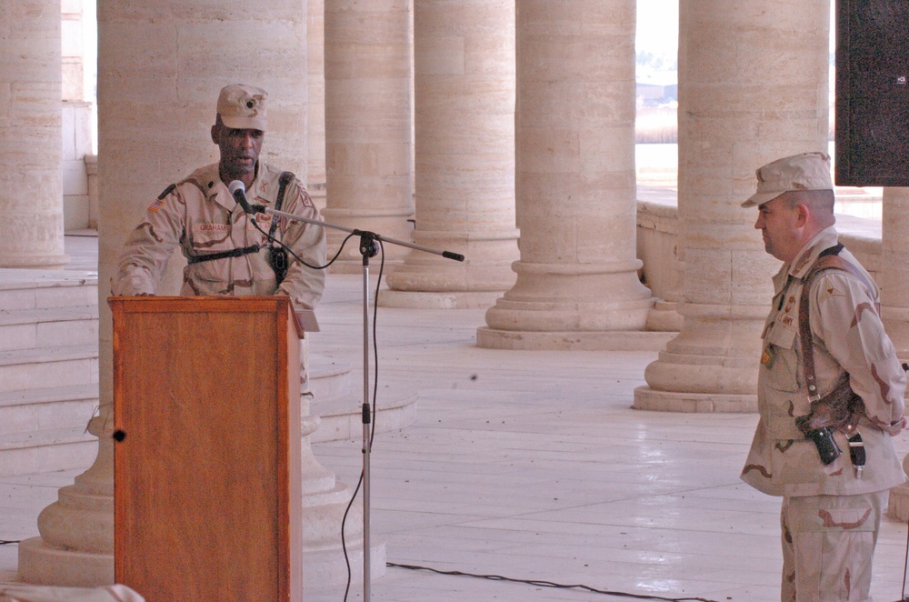 Lt. Col. Timotheus Graham praises Lt. Col. Raymond Lacey