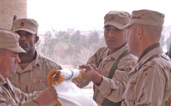 Lt. Col. Raymond Lacey rolls his units guidon