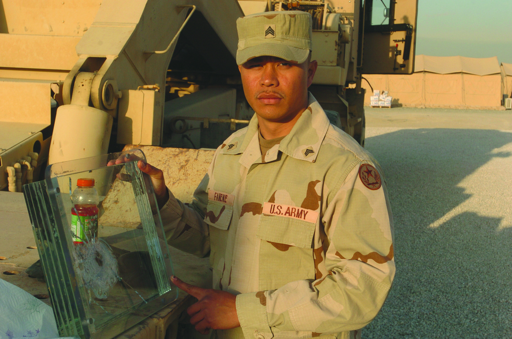 Sgt. Sefo Fanene Displays a Ballistic Humvee Window Sgt. Sefo Fanene Displays a Ballistic Humvee Window