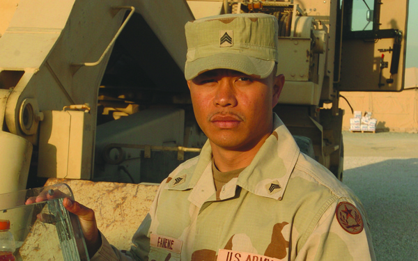 Sgt. Sefo Fanene Displays a Ballistic Humvee Window