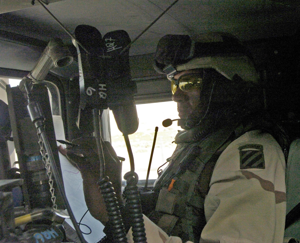 Lt. Col. Brito studies his maps and Blue Force Tracker screen