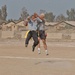 Two soldiers go up for the ball during flag football