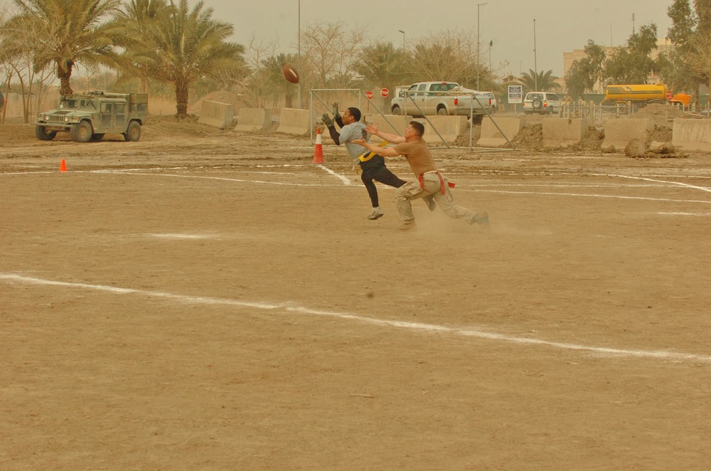 Opposing team members jockey for position to catch the ball