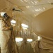 Andy Larson sprays protective polyurethane coating on an tanker