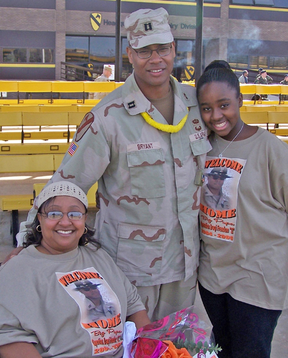 Capt. Reginald Bryant stands with his wife and daughter