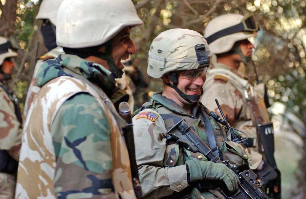 Sgt. Michael Cooper shares a laugh with his counterpart