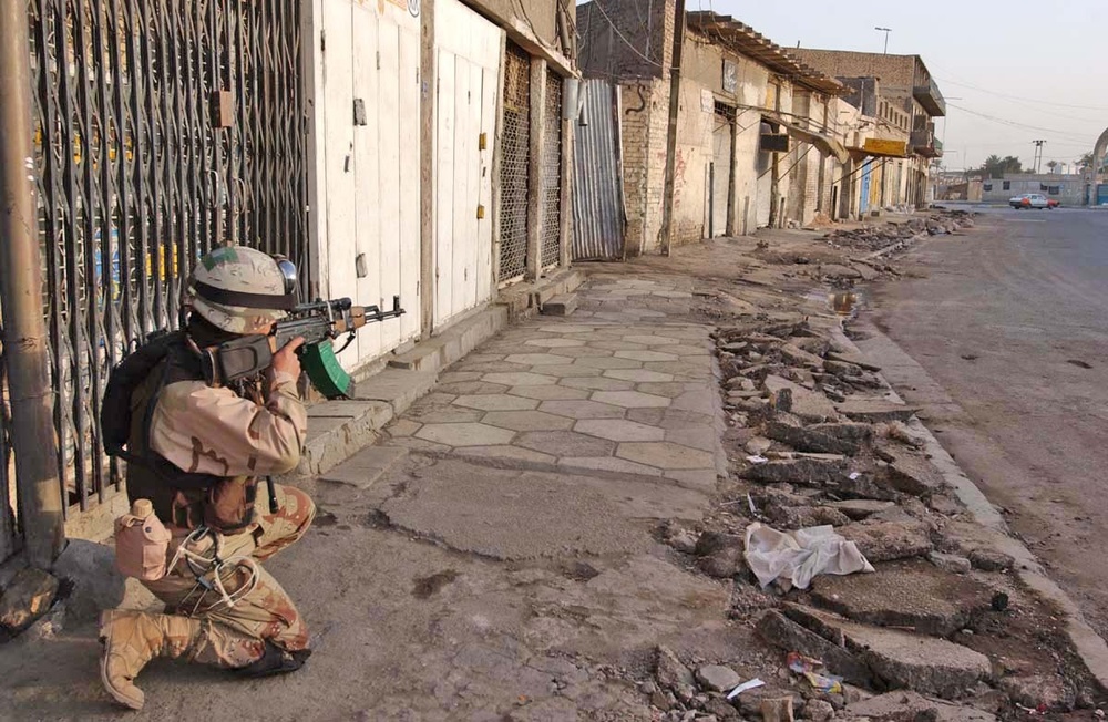 A Soldier takes aim at a vehicle attempting to enter