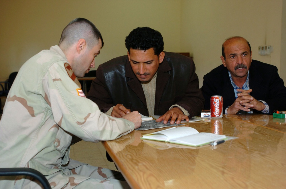 1st Lt. Allen goes over a map schem with an council member