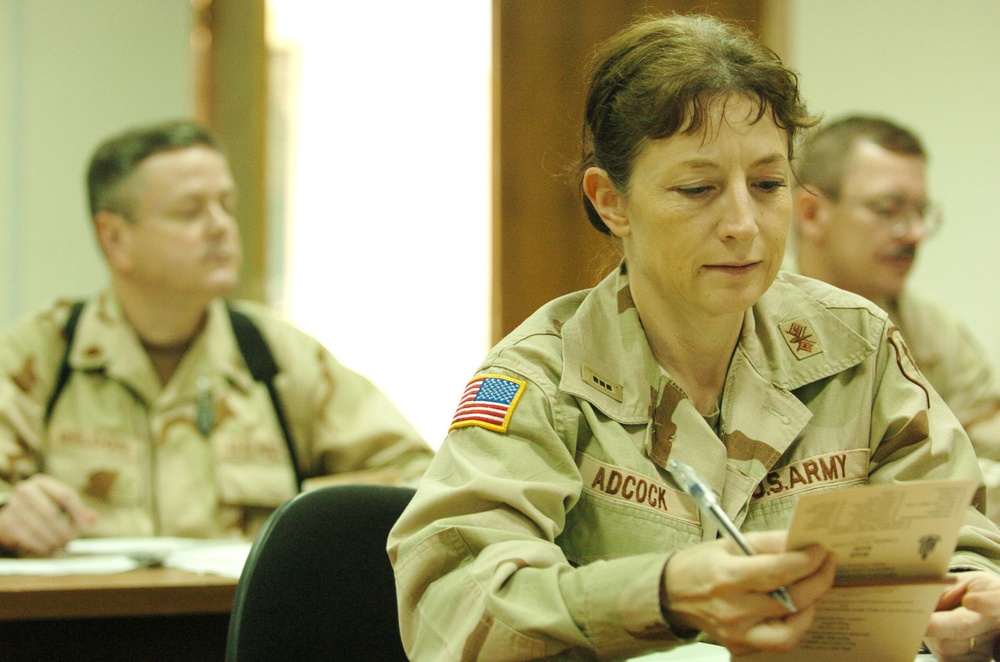 CWO Adcock studies phrases out of her Arabic book