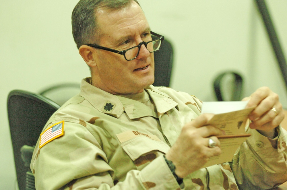 Lt. Col. David R. Brock reads phrases out his Arabic book
