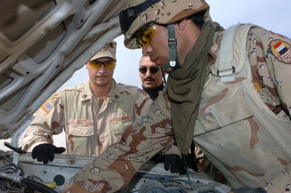 Staff Sgt. Mark Scott Instructs an Iraqi Army Soldier