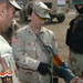 Staff Sgt. Mark Scott Inspects an Iraqi Army Soldier Rifle