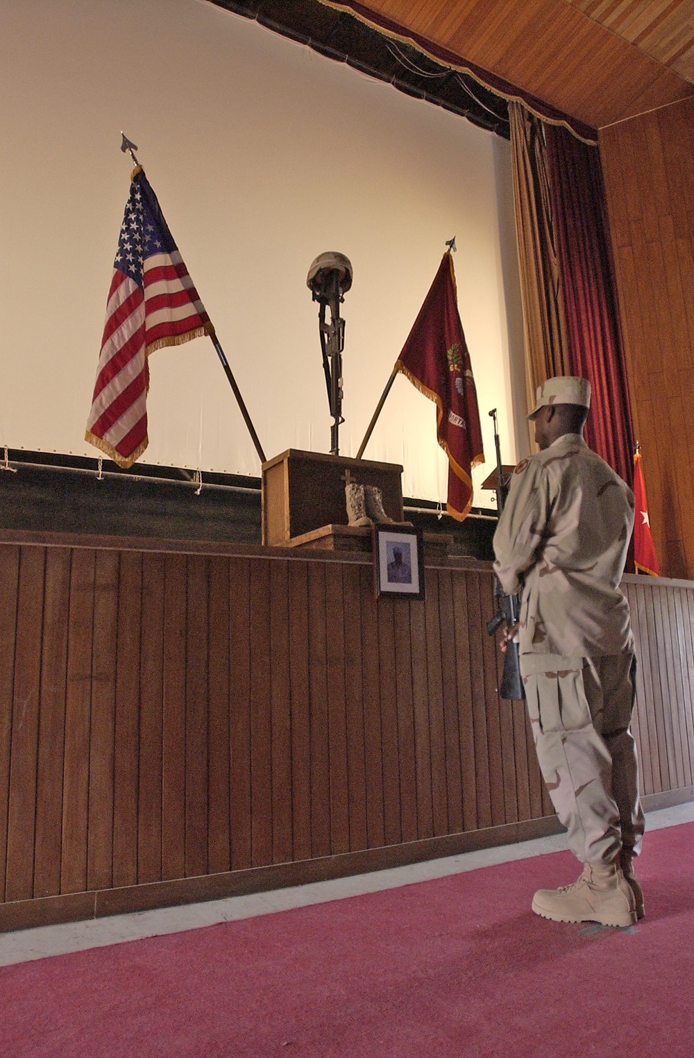 A member of the funeral detail pays his respect